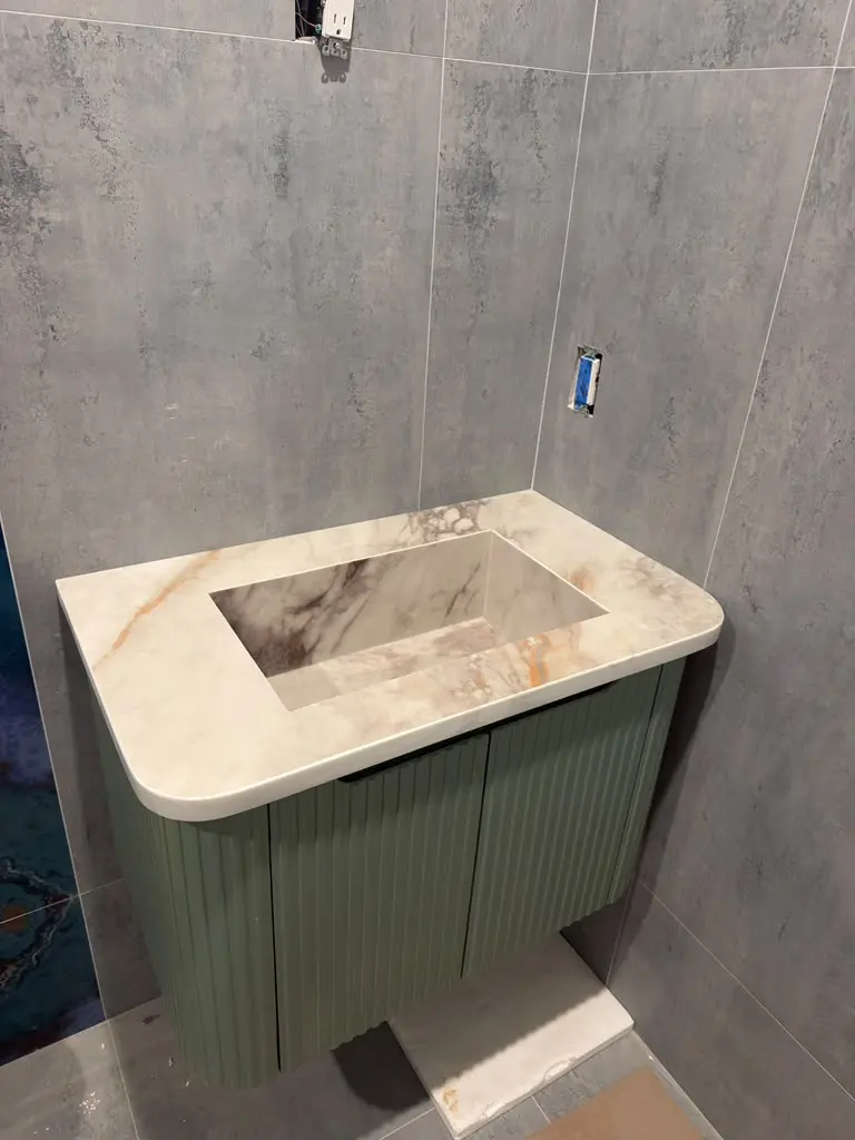 Custom stone bathroom vanity top with integrated rectangular sink
