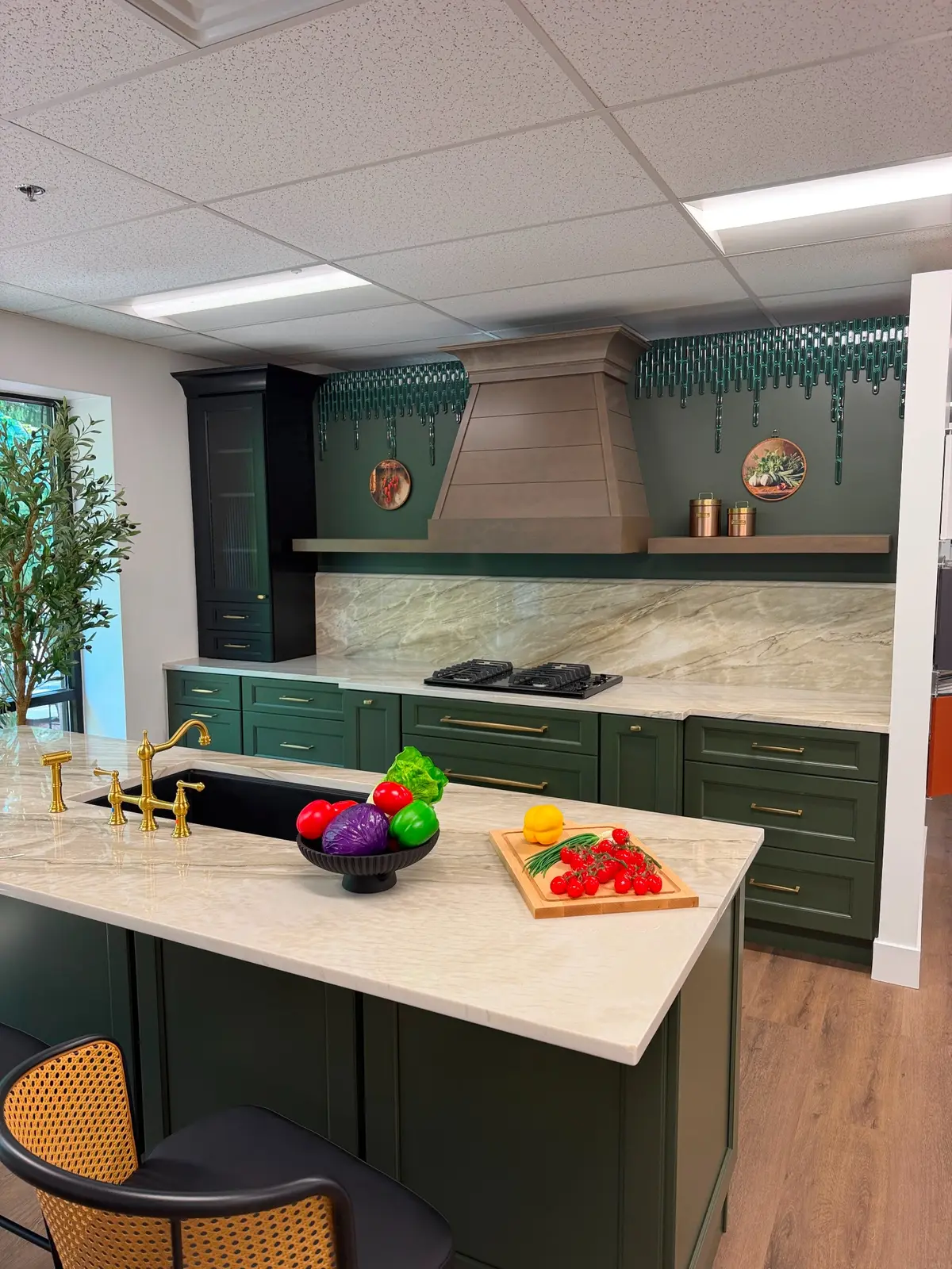 Green kitchen with stone island, countertop and full height backsplash
