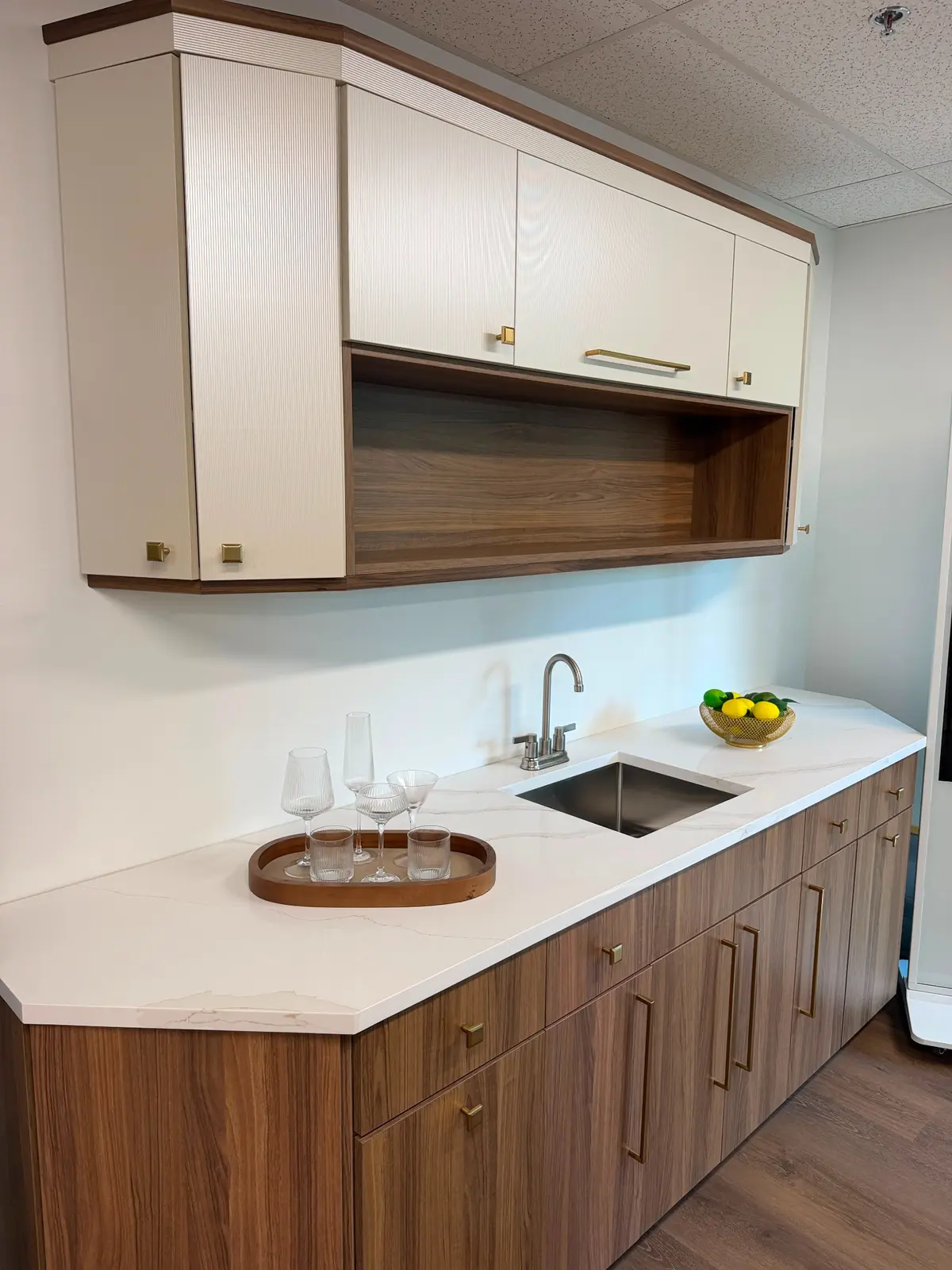 White stone wet bar countertop with undermount sink and wood cabinetry